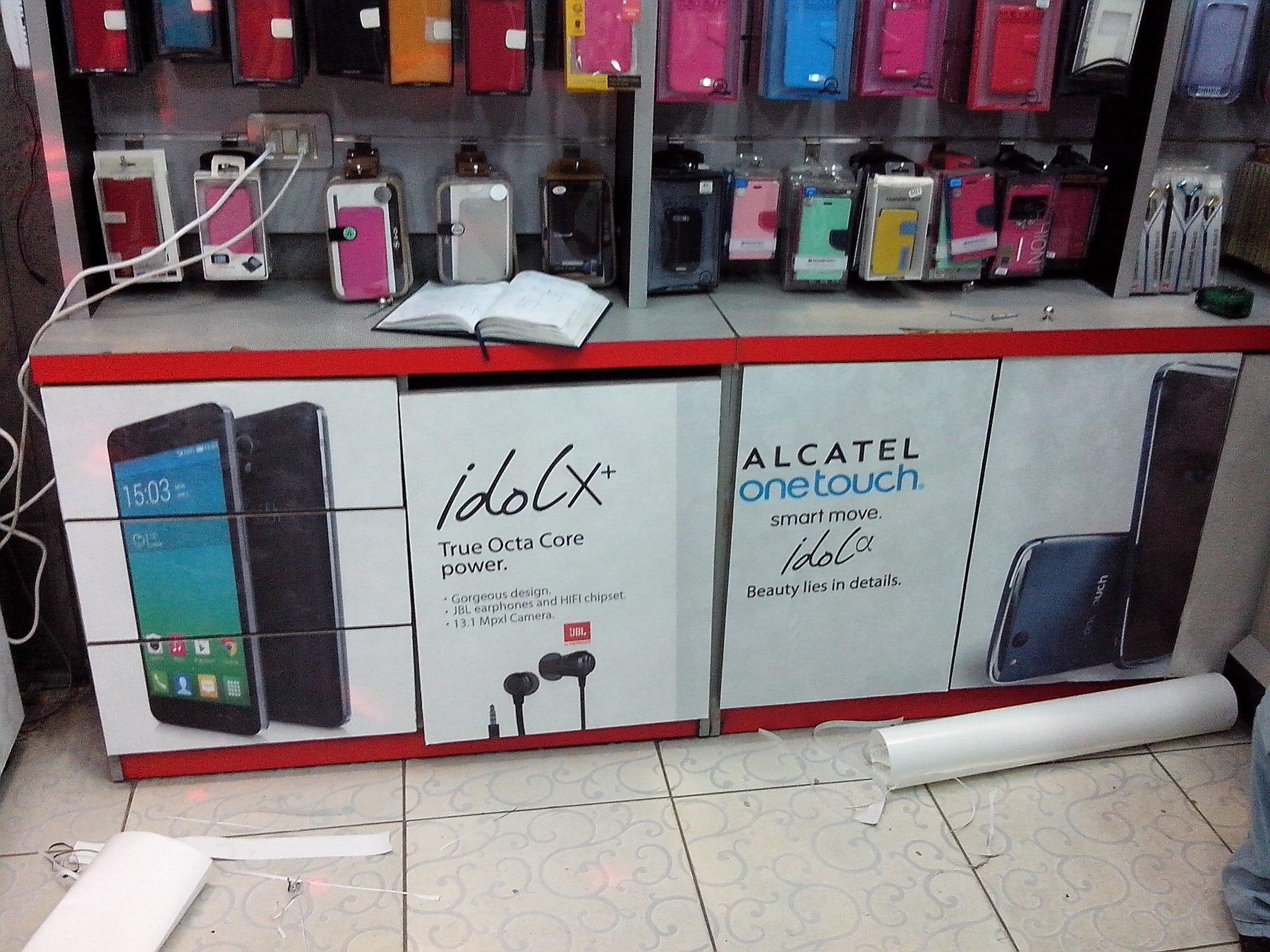 Printed wall panels above a phone-shop counter