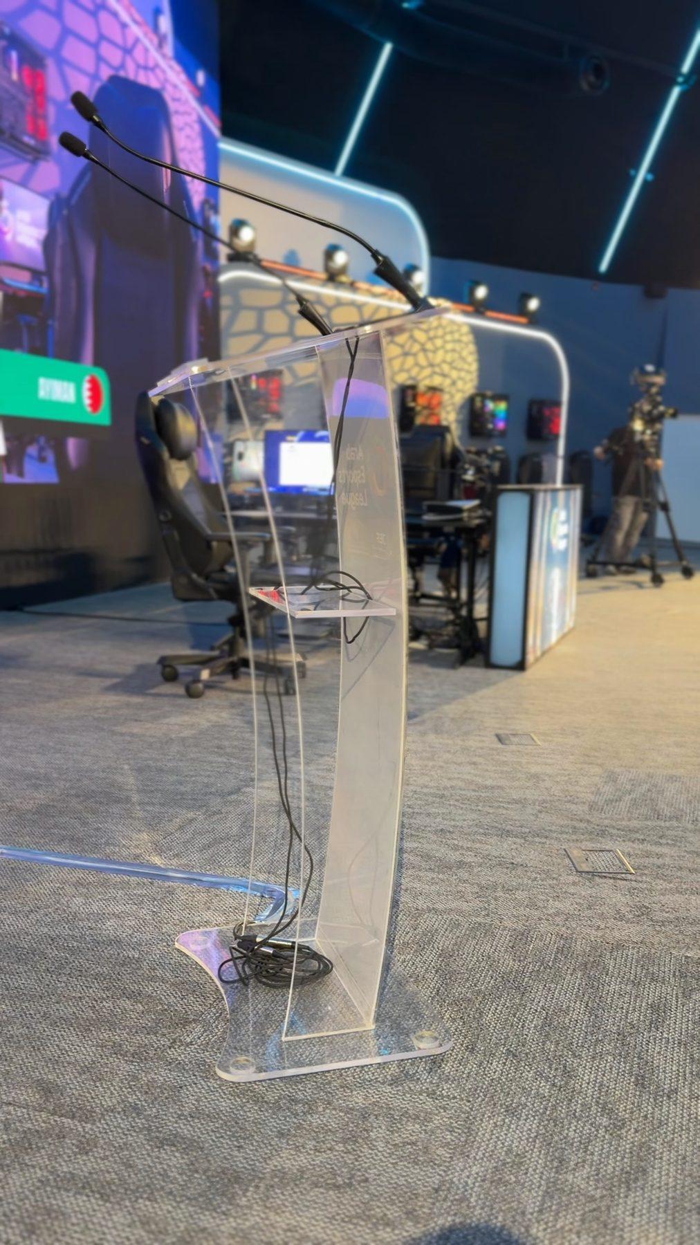 Clear acrylic lectern on the competition floor.