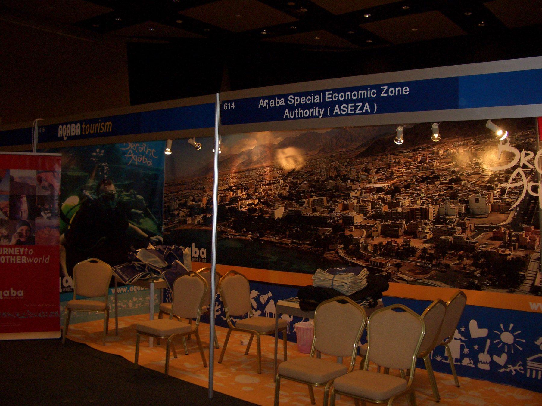 Exhibition booth with panoramic printed backdrop and roll-up banners