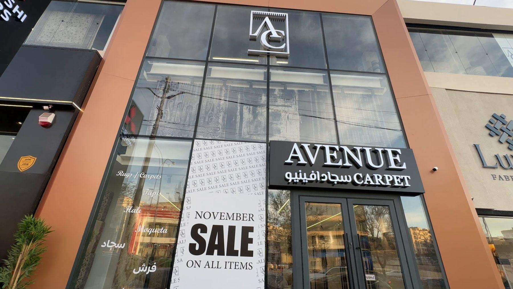 The full facade with the sale window graphics.