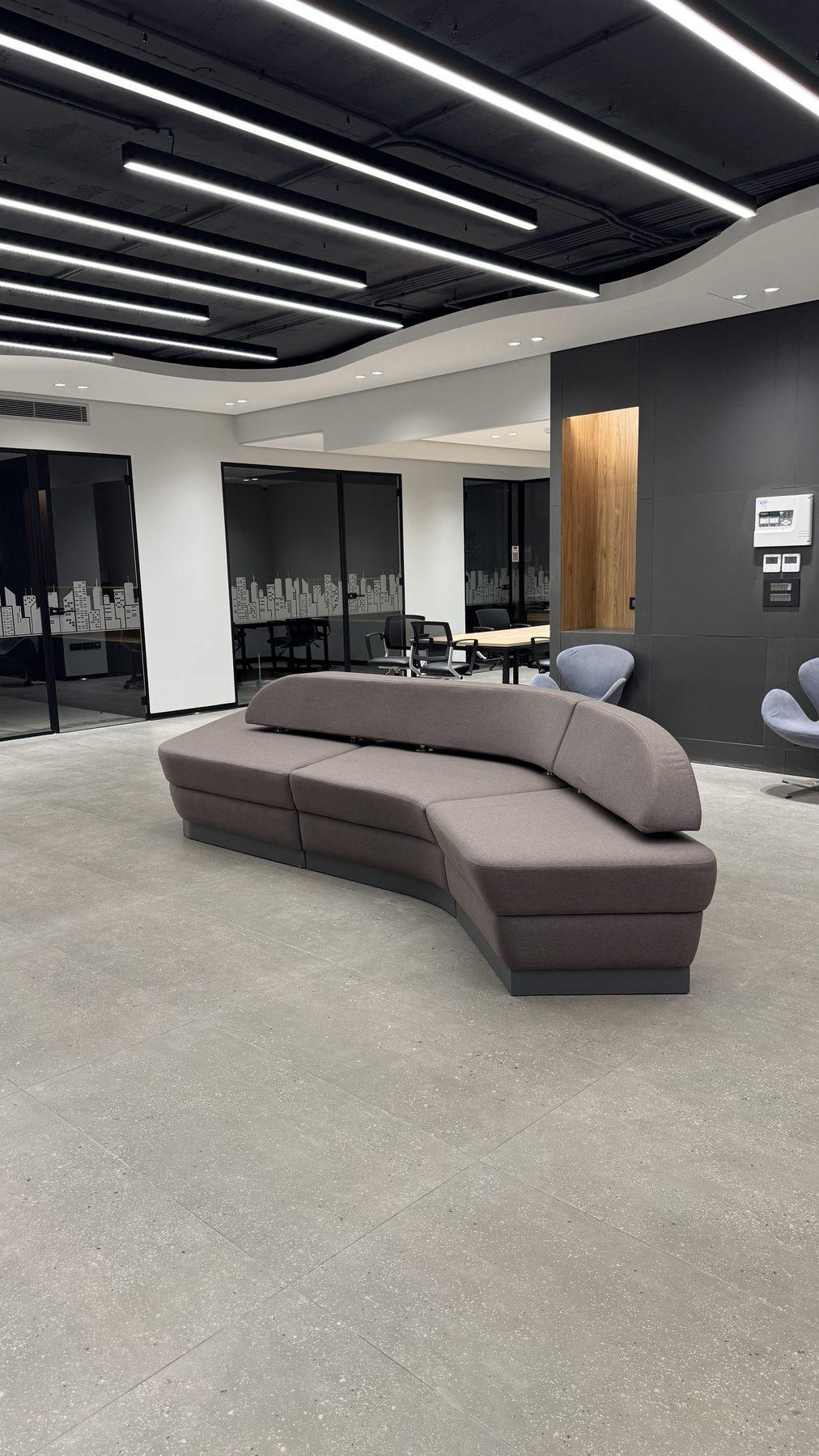 The lounge under the curved ceiling with linear LED lighting.