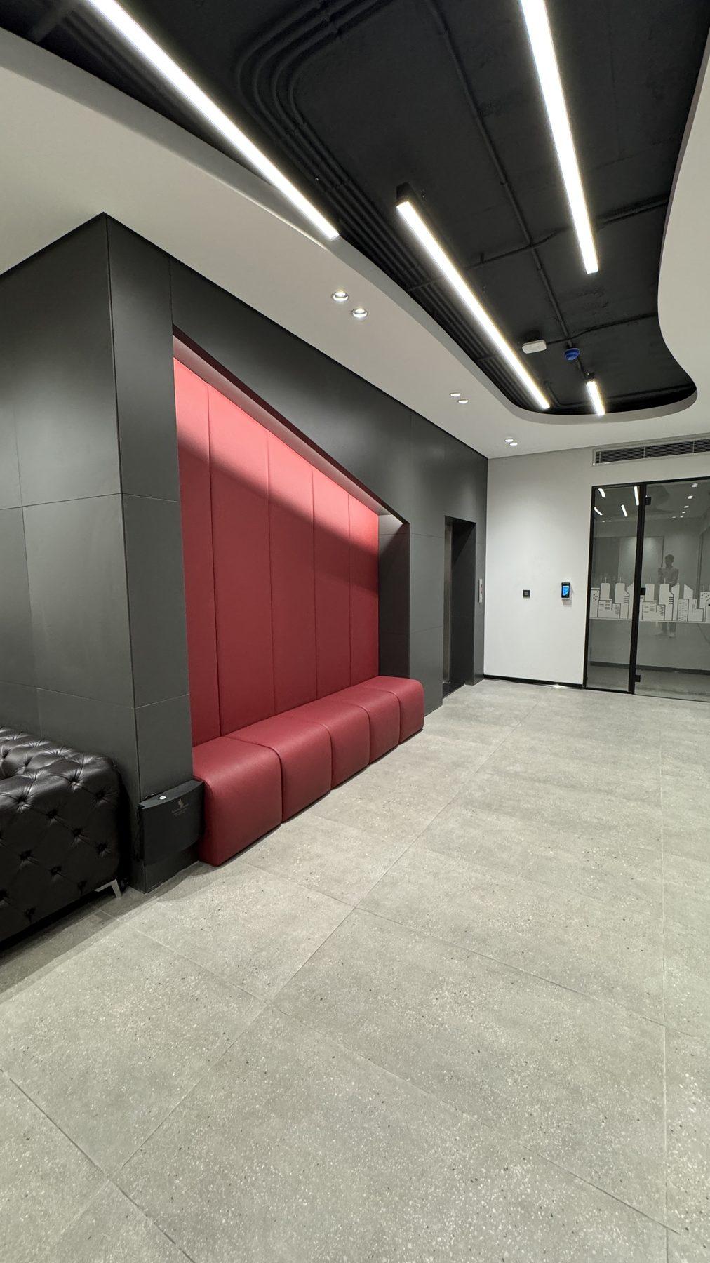 The red upholstered booth set into a dark wall.