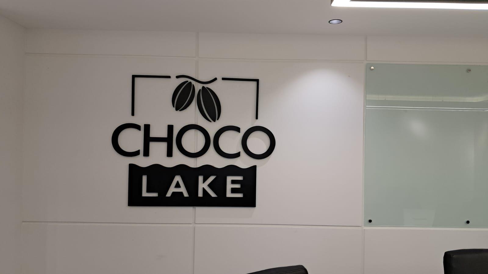 Logo with cocoa beans and block lettering on a white interior wall