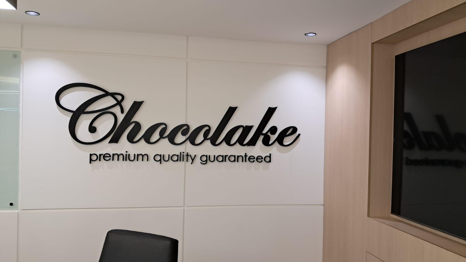Dimensional script lettering with tagline on a white interior wall