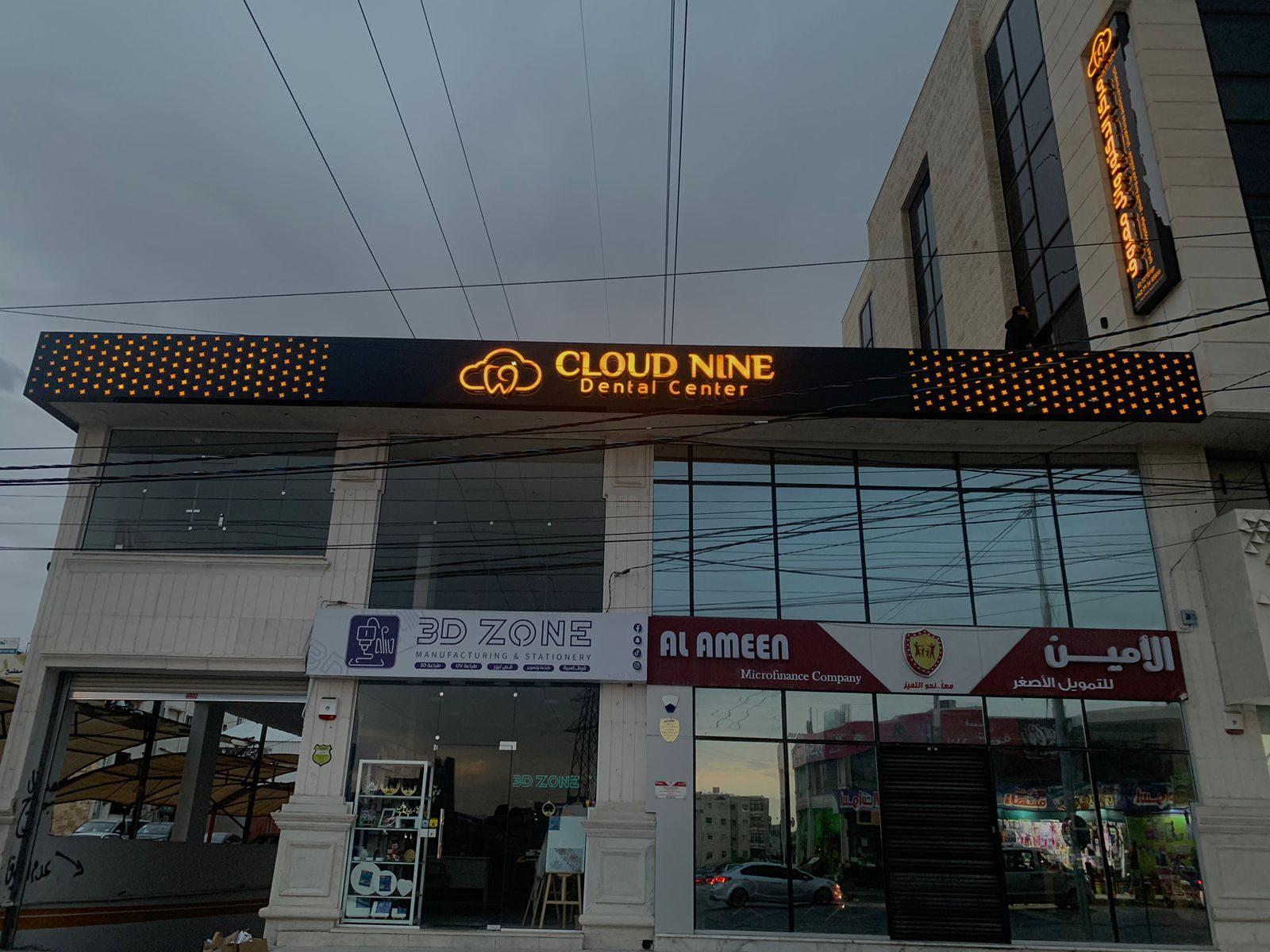 Illuminated dental clinic fascia on the upper facade of a building