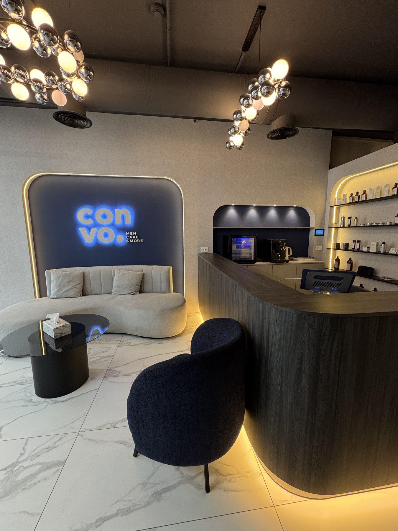 Reception: the halo-lit logo wall, lounge and counter.