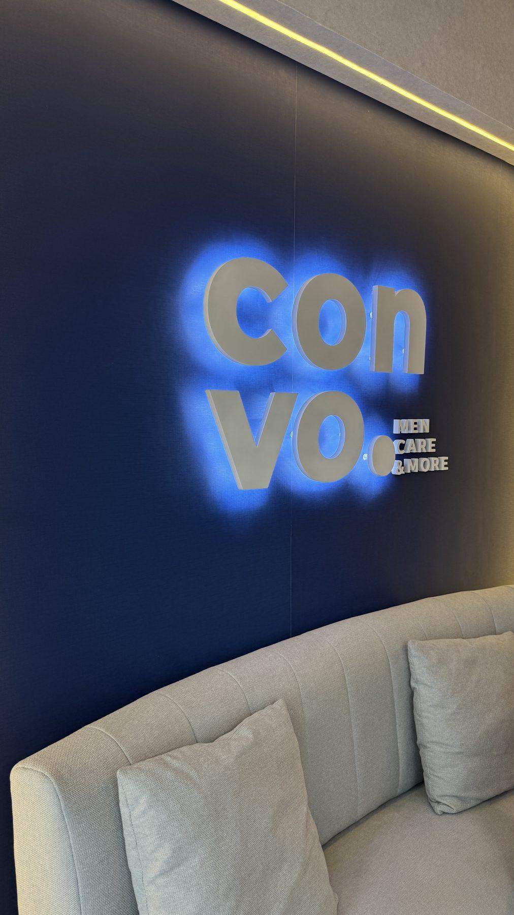 The halo-lit Convo logo on the blue wall.