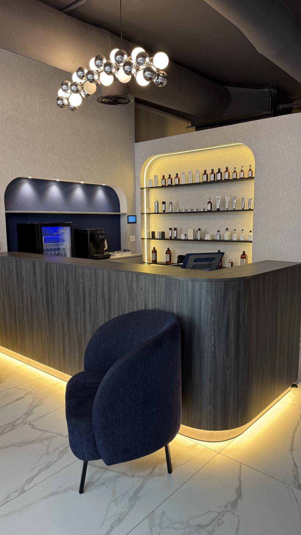 The reception counter with its LED under-glow and lit shelving.