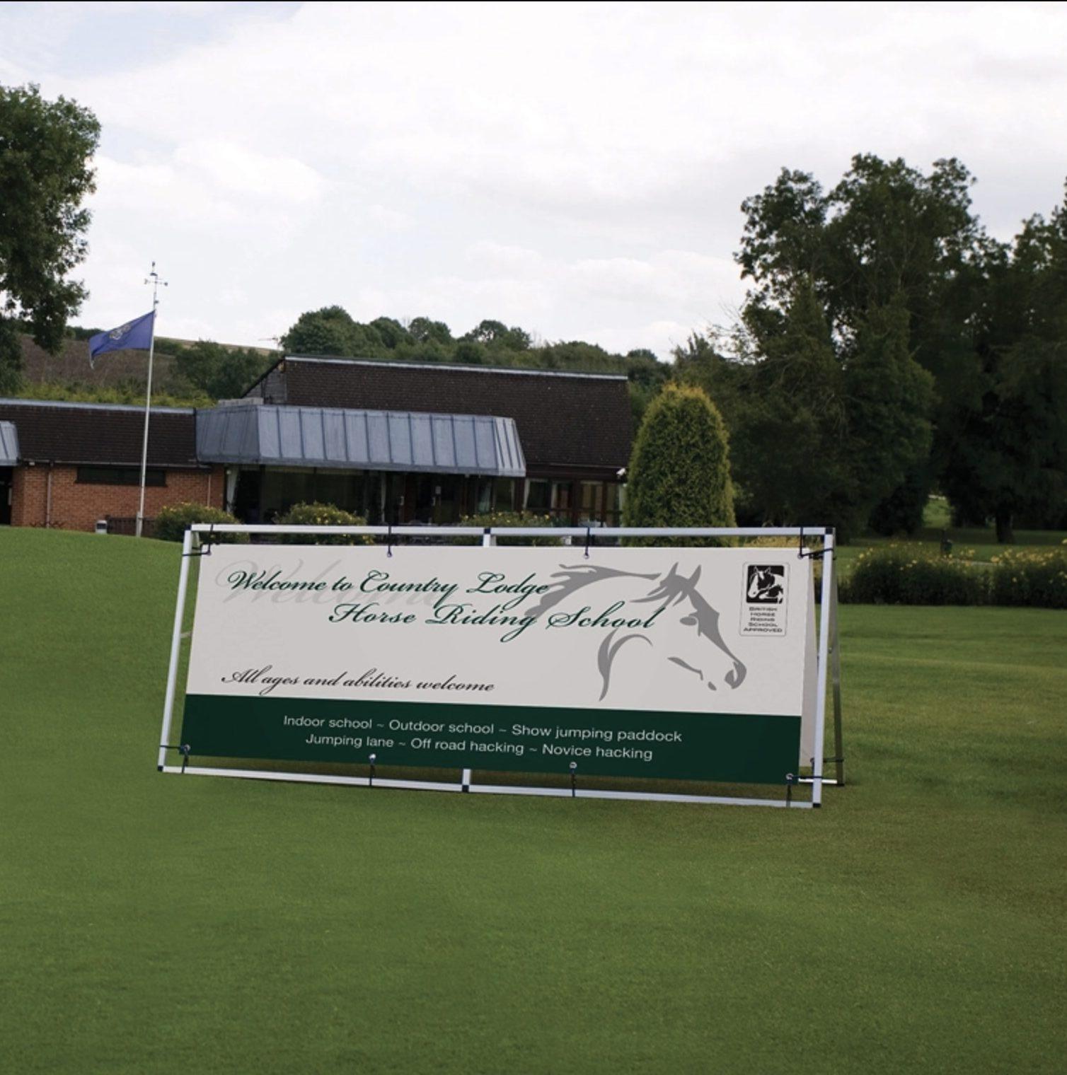 Printed white and green freestanding sign panel on a lawn
