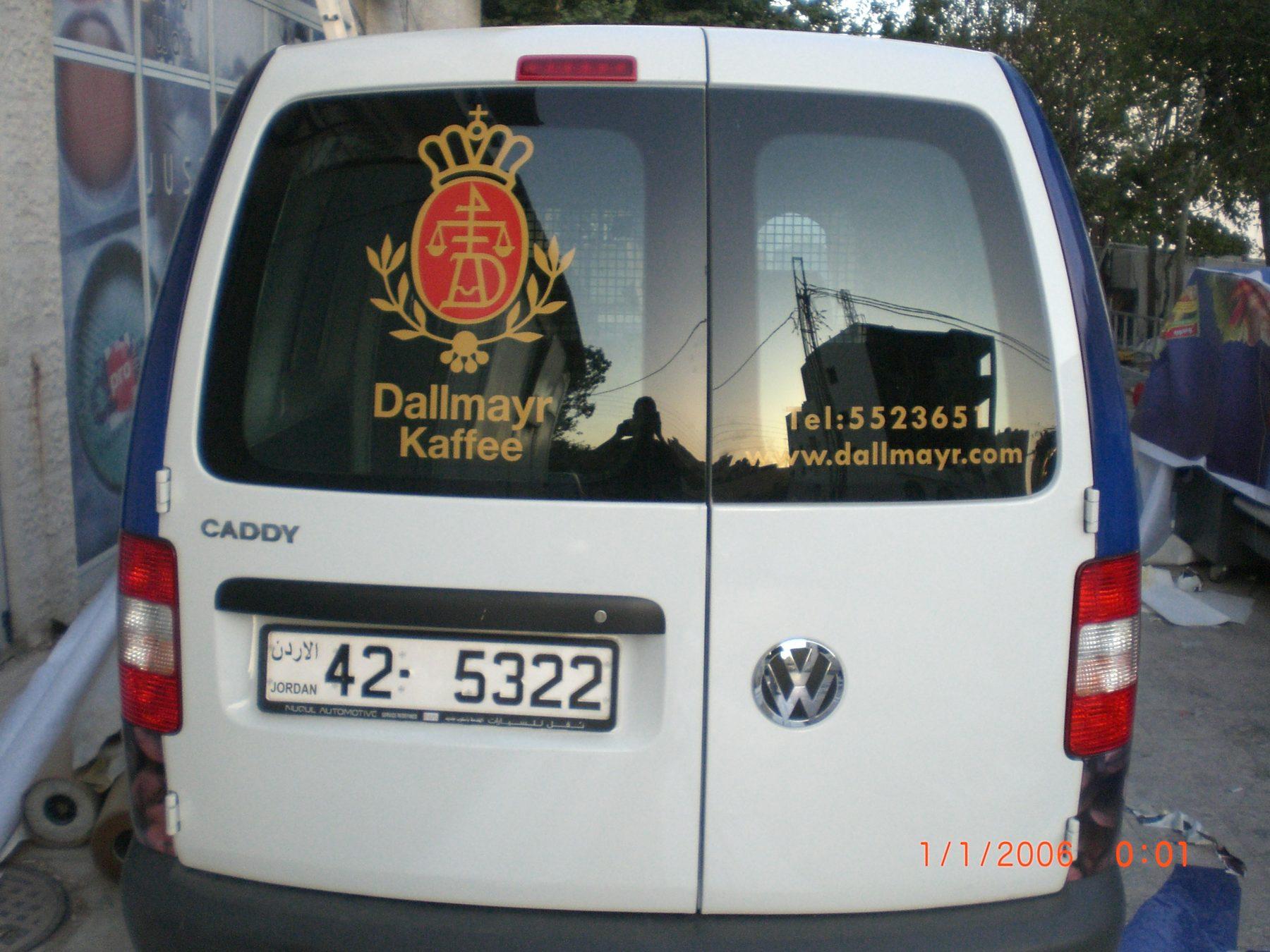 Rear of a van with crest and contact details on the doors