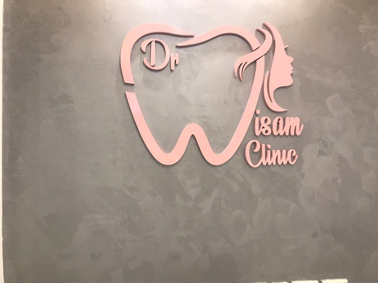 Dimensional pink logo on a grey wall