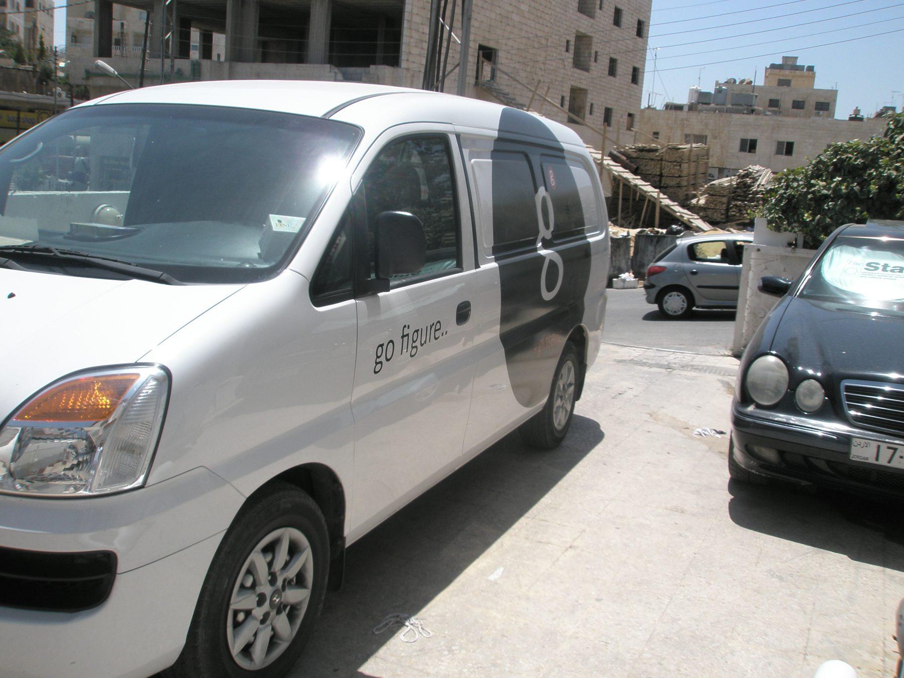 Front three-quarter view of the van with side graphic