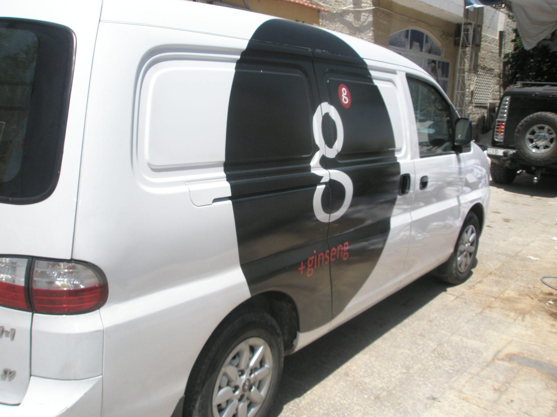 Rear three-quarter view showing the black panel and letter mark