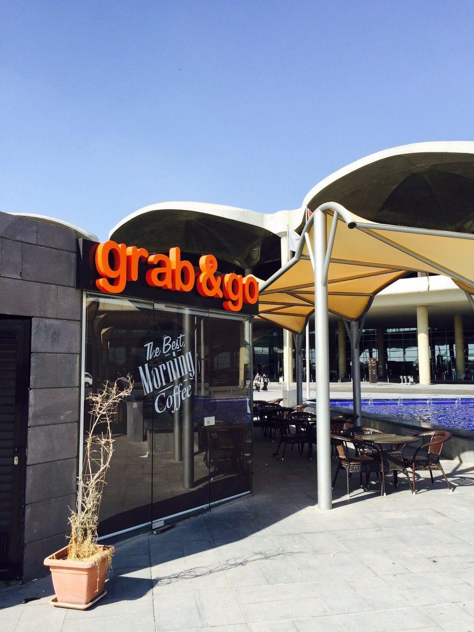 Orange fascia lettering above a coffee shop under an awning