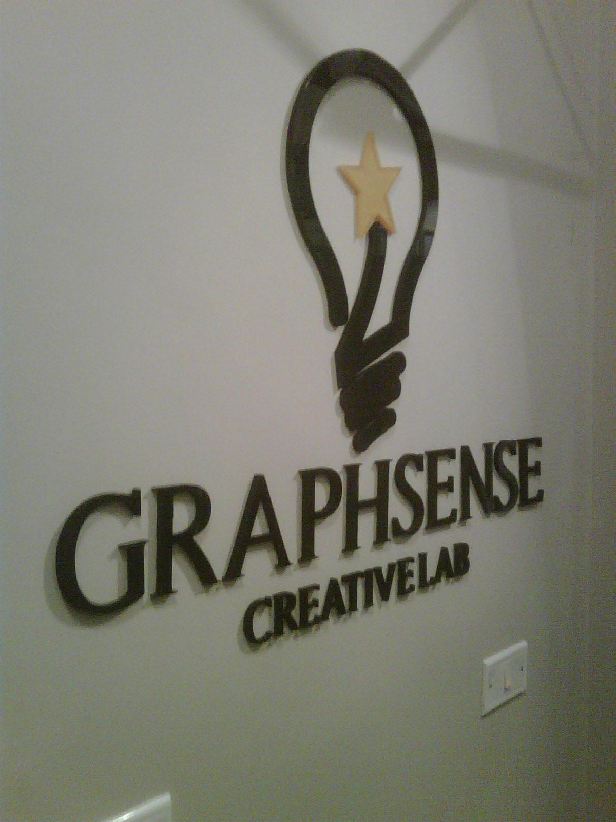 Dimensional logo mark and wordmark on a light wall
