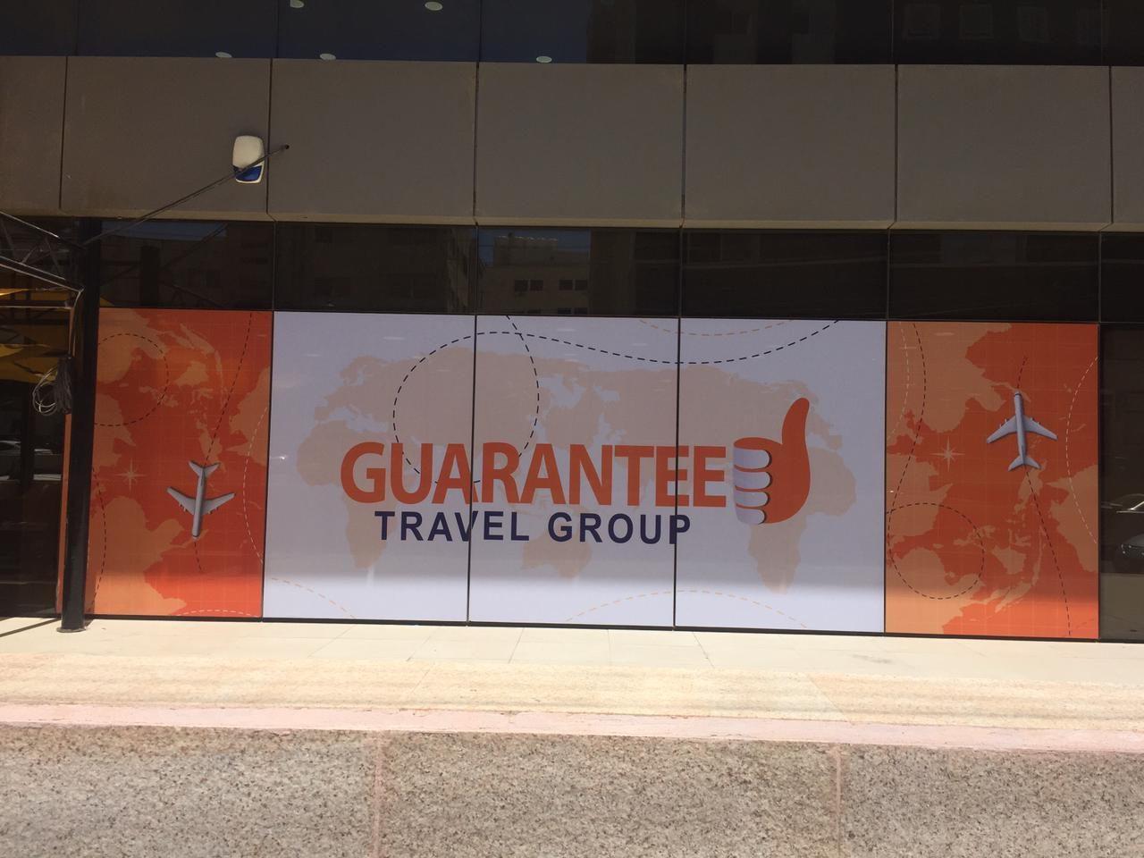 Printed travel-themed graphic panels across a shopfront