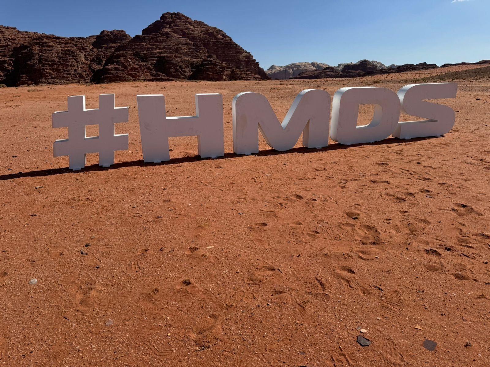 Three-dimensional hashtag letters set in the desert sand.
