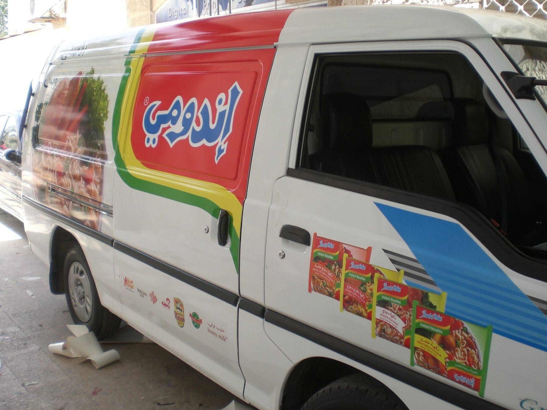 Van side with noodle packs and rainbow stripe