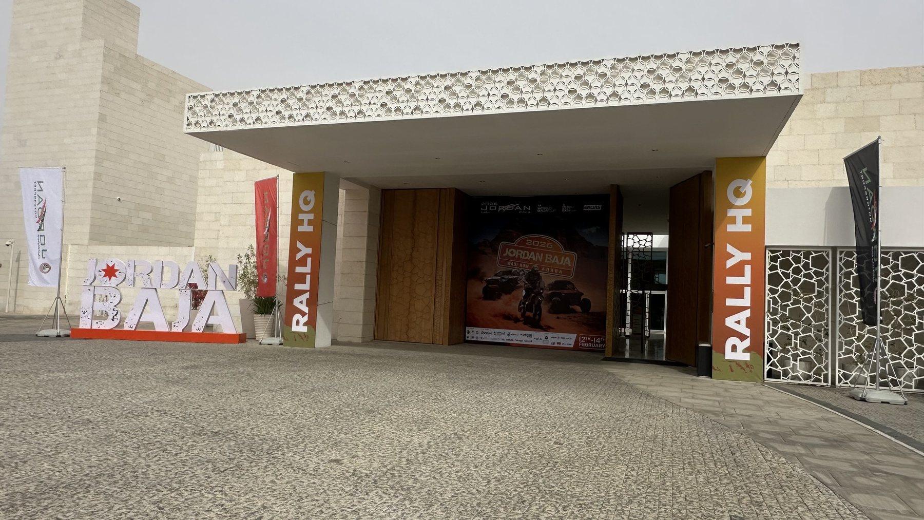 The entrance of a building decorated with branded flags and rally headquarters banners.