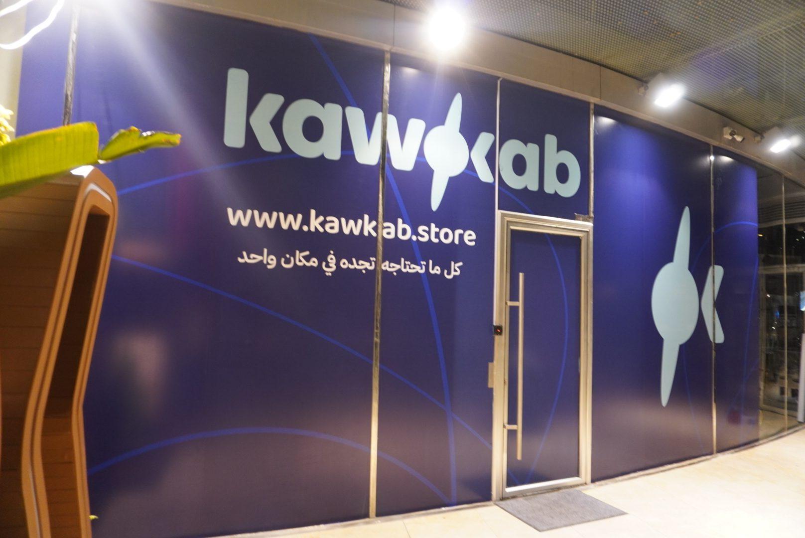 Navy wall with white logo and web address beside the entrance