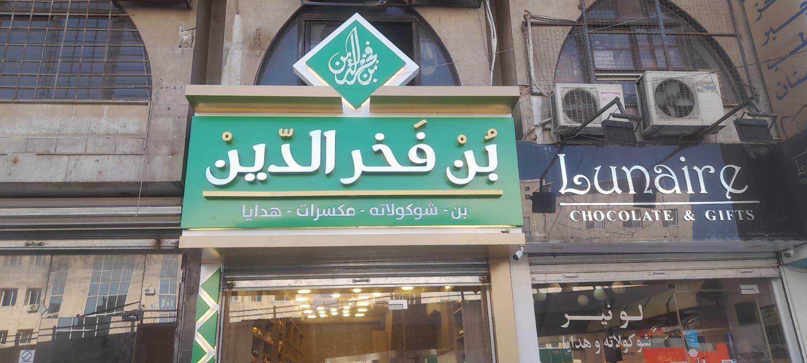 Dark fascia with white lettering above a shop entrance