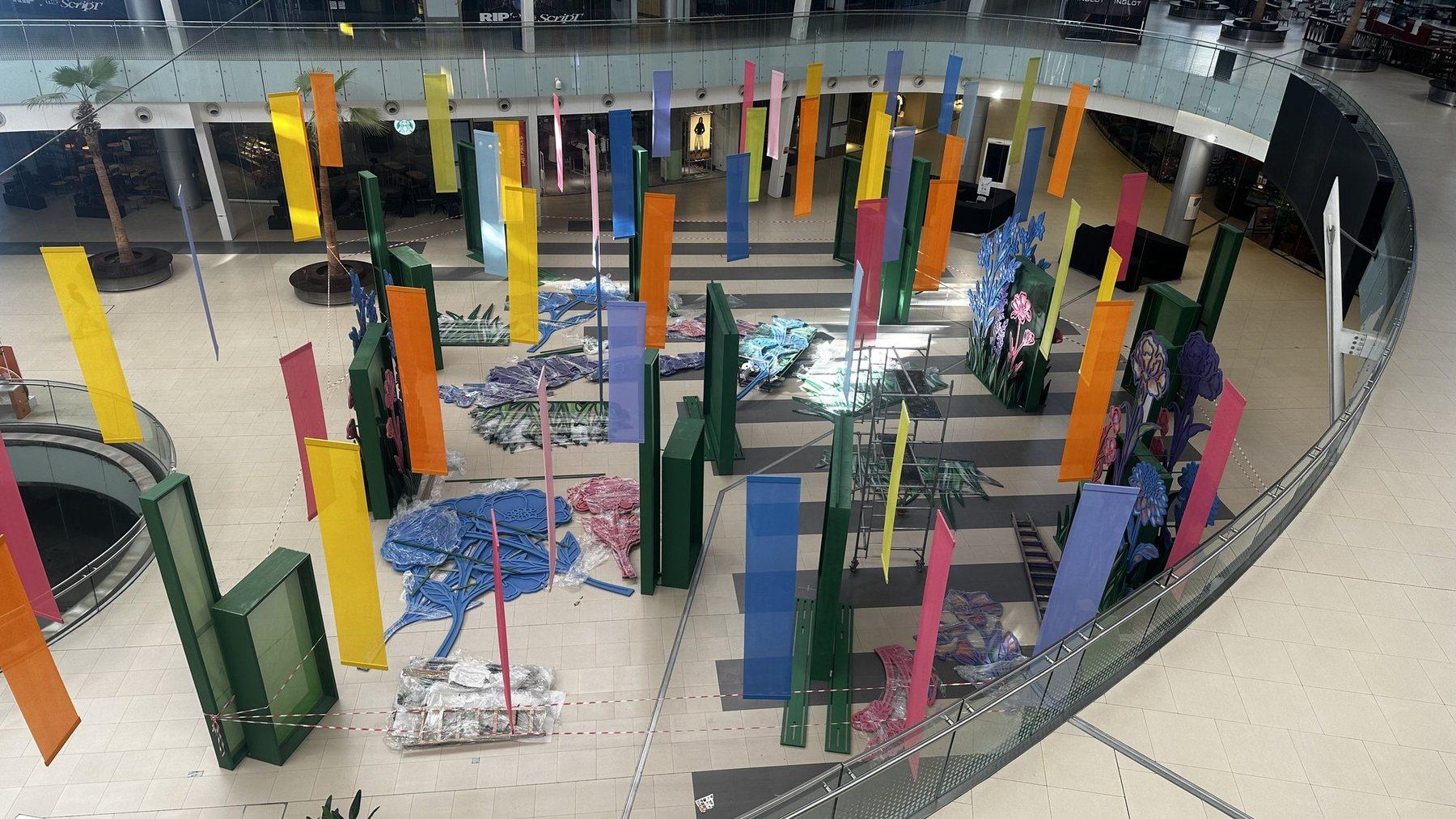Elevated view of tall coloured panels and green pillars around a central display.