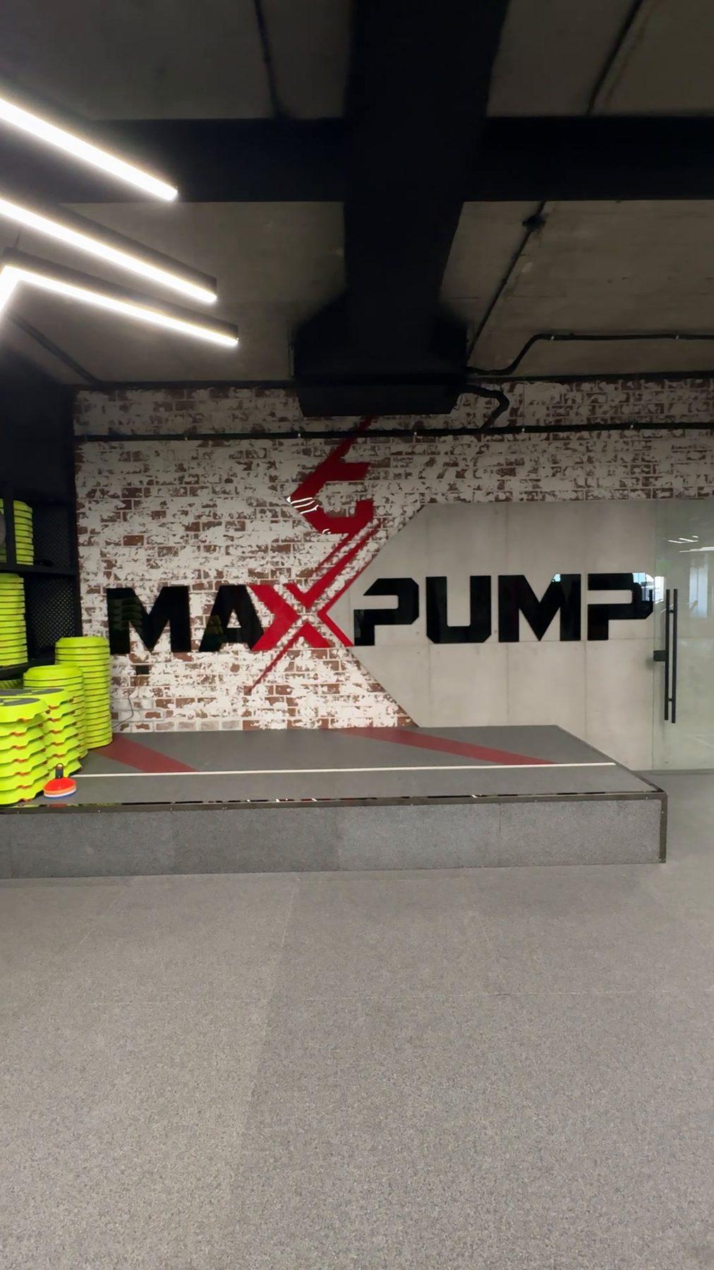 The Max Pump logo on a feature wall above the training area.