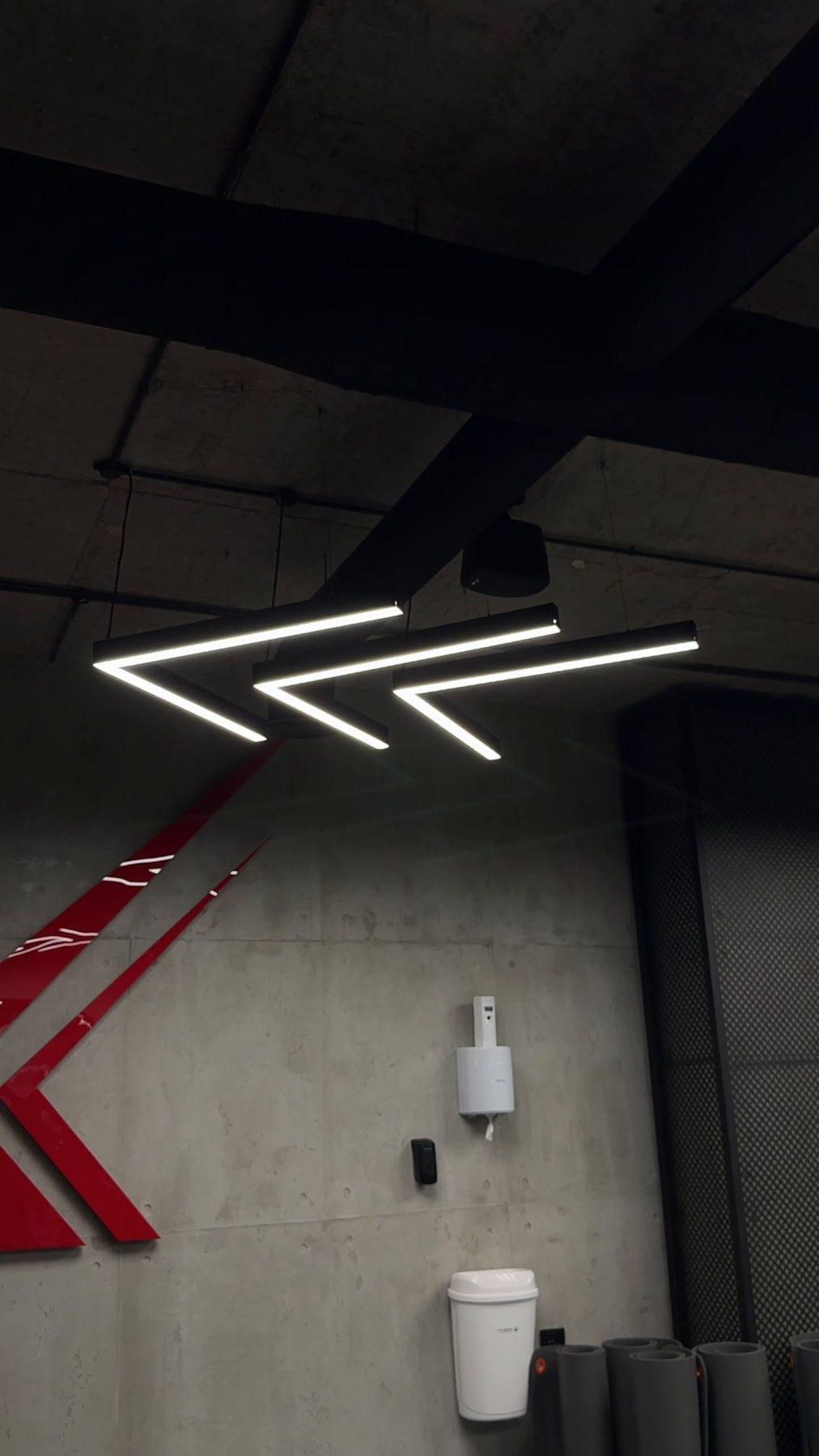 LED line lighting forming the brand's arrow on the ceiling.