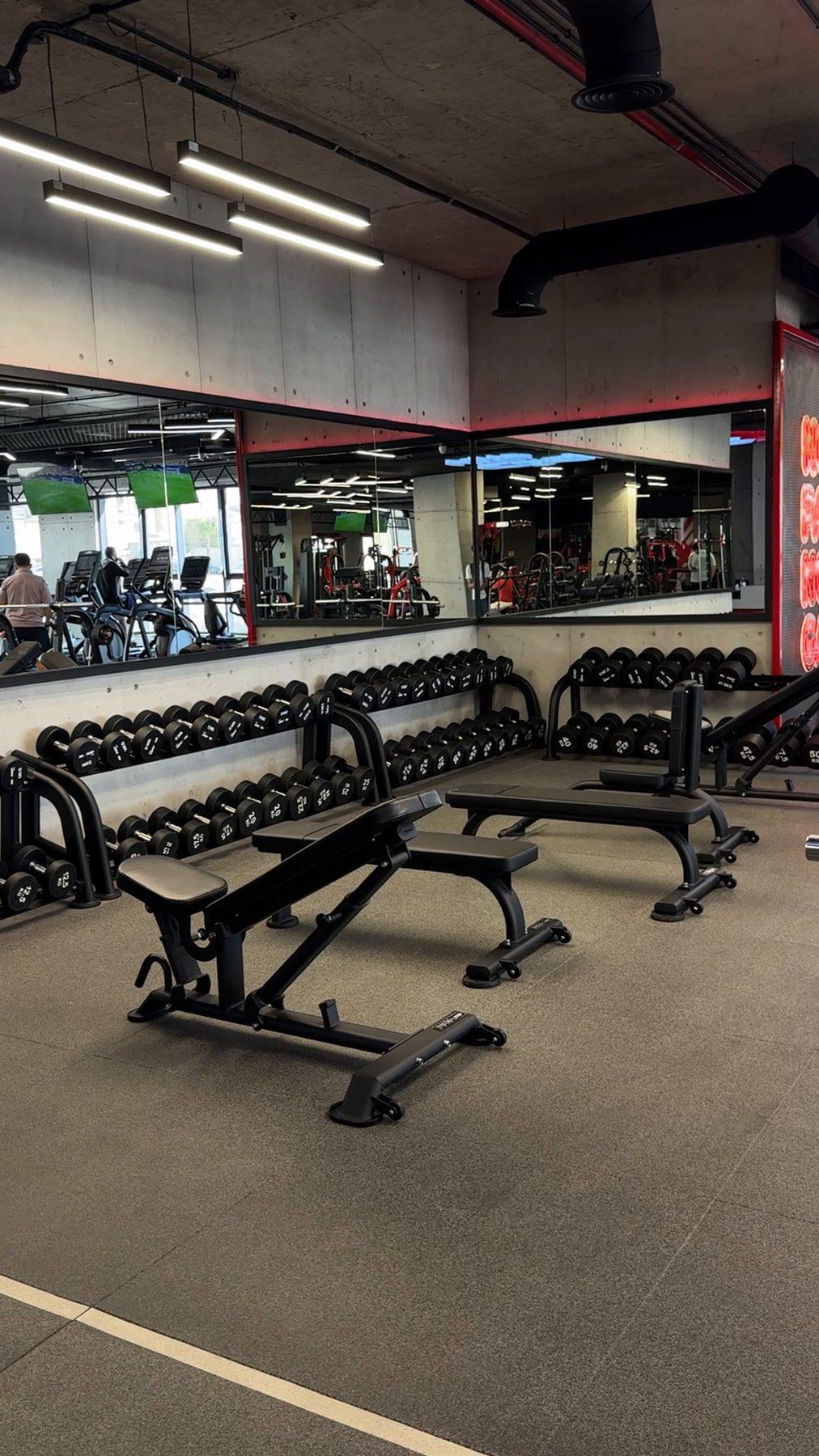 The weights area under the branded ceiling lighting.