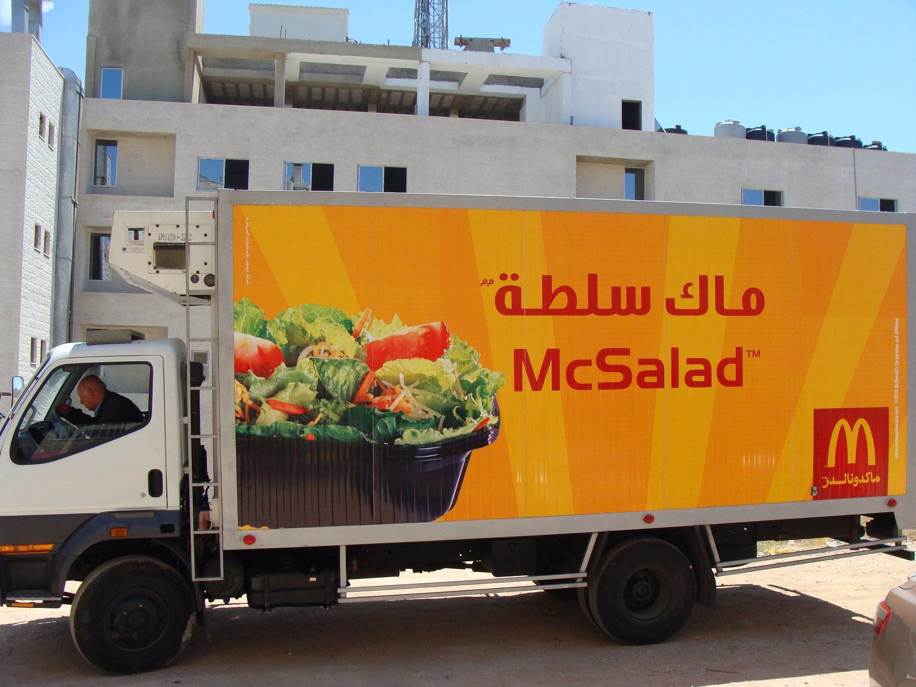 Box truck side with orange salad artwork and logo