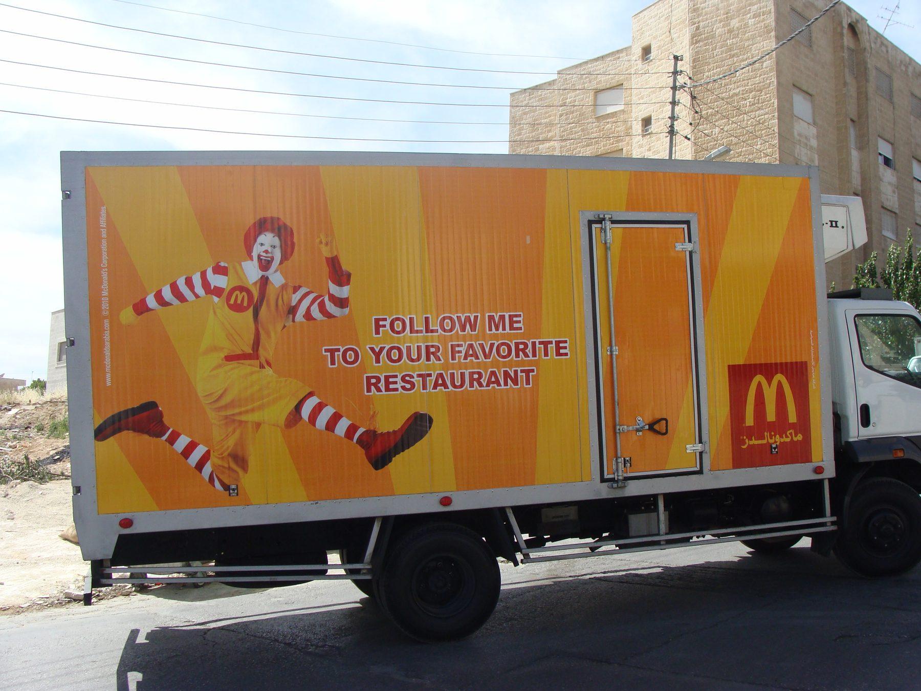Orange box truck side with campaign line and character graphic