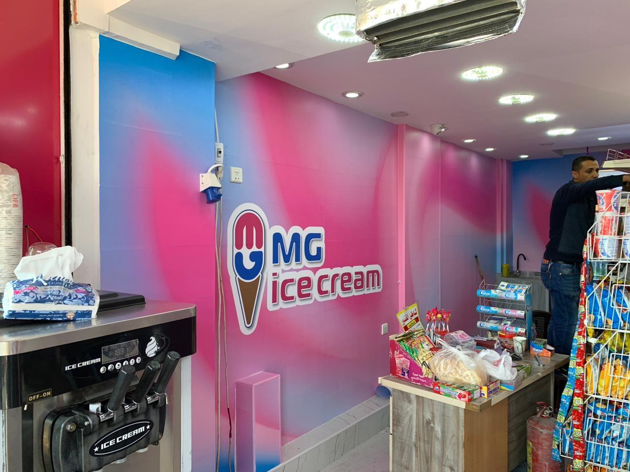 Pink and blue wall graphic with logo behind the counter
