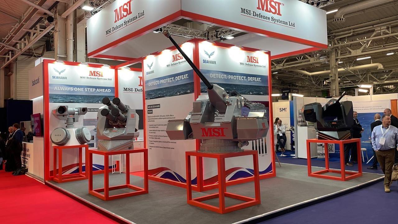Exhibition stand with red-framed structures and a display vehicle