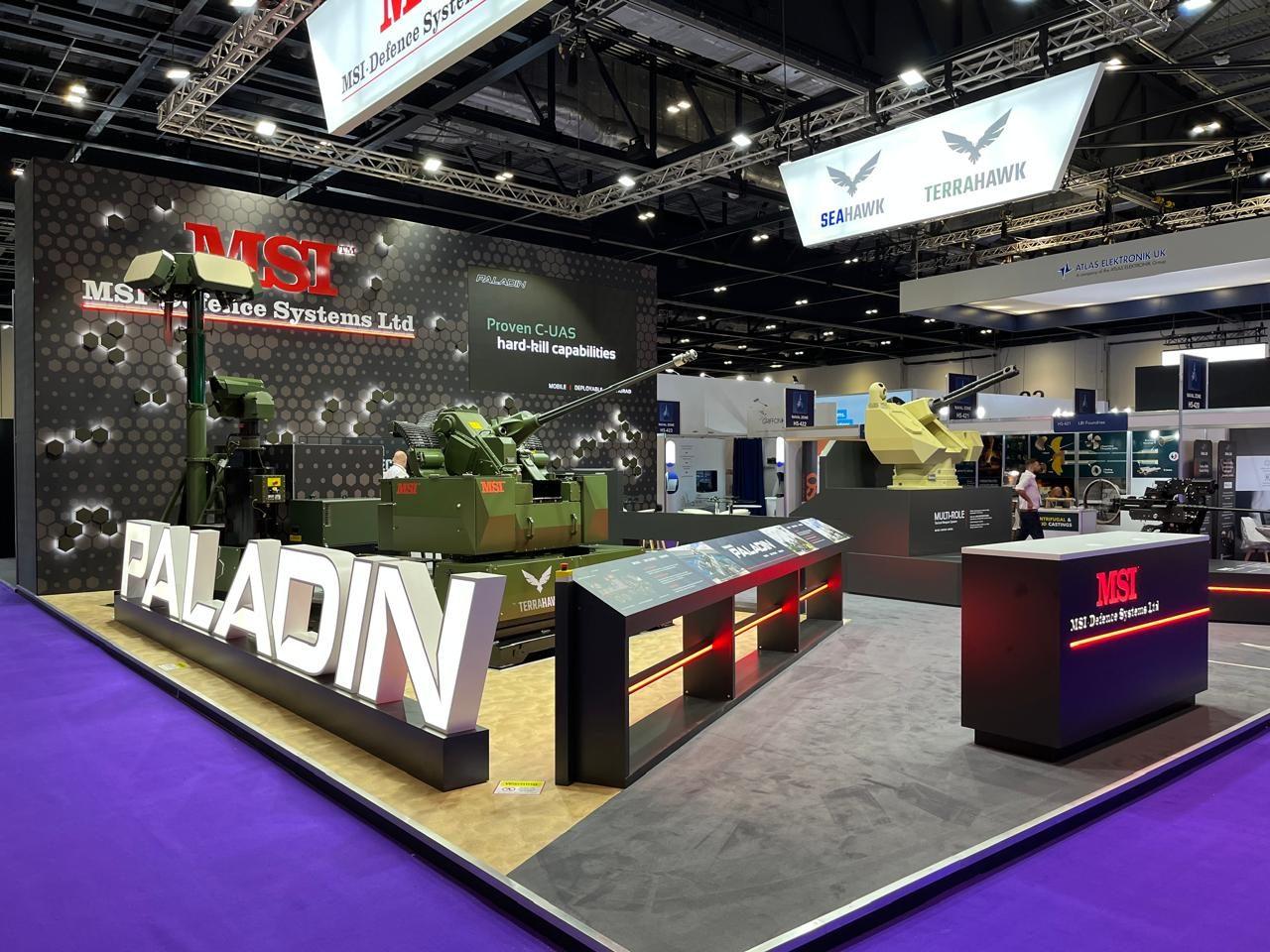 Wide view of the stand with 3D letters and a vehicle display