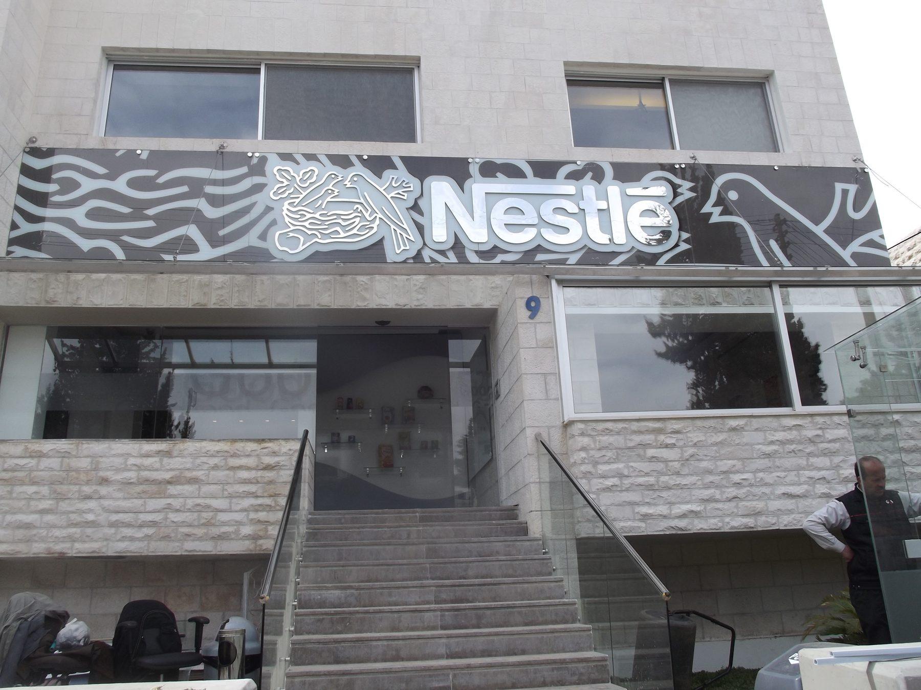 Printed panel with logo above the entrance