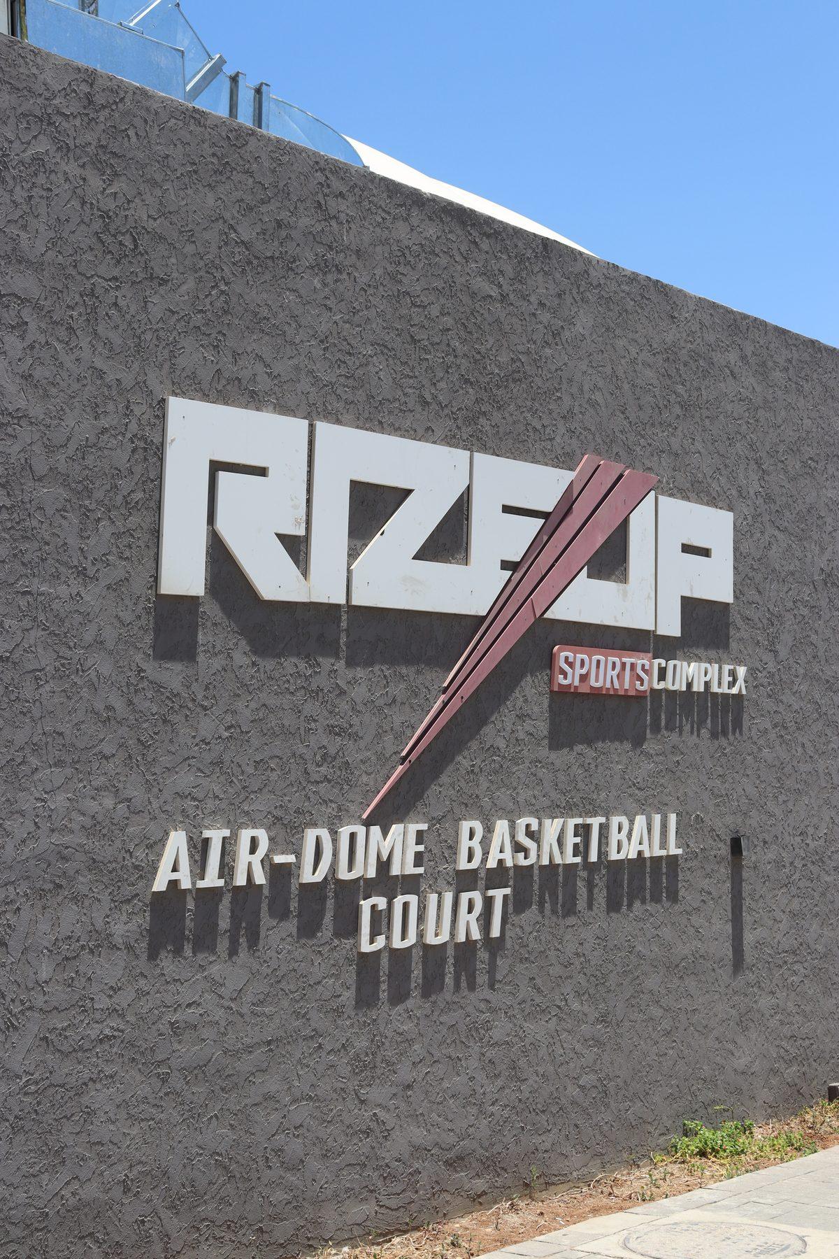 The wall sign from the side, showing the raised letters.