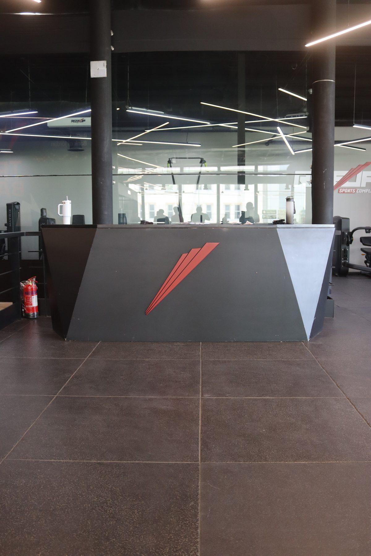 The angular reception counter with the red brand mark.