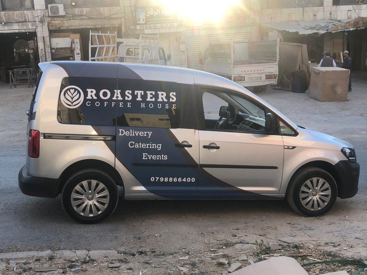 Silver van with side lettering for delivery, catering and events