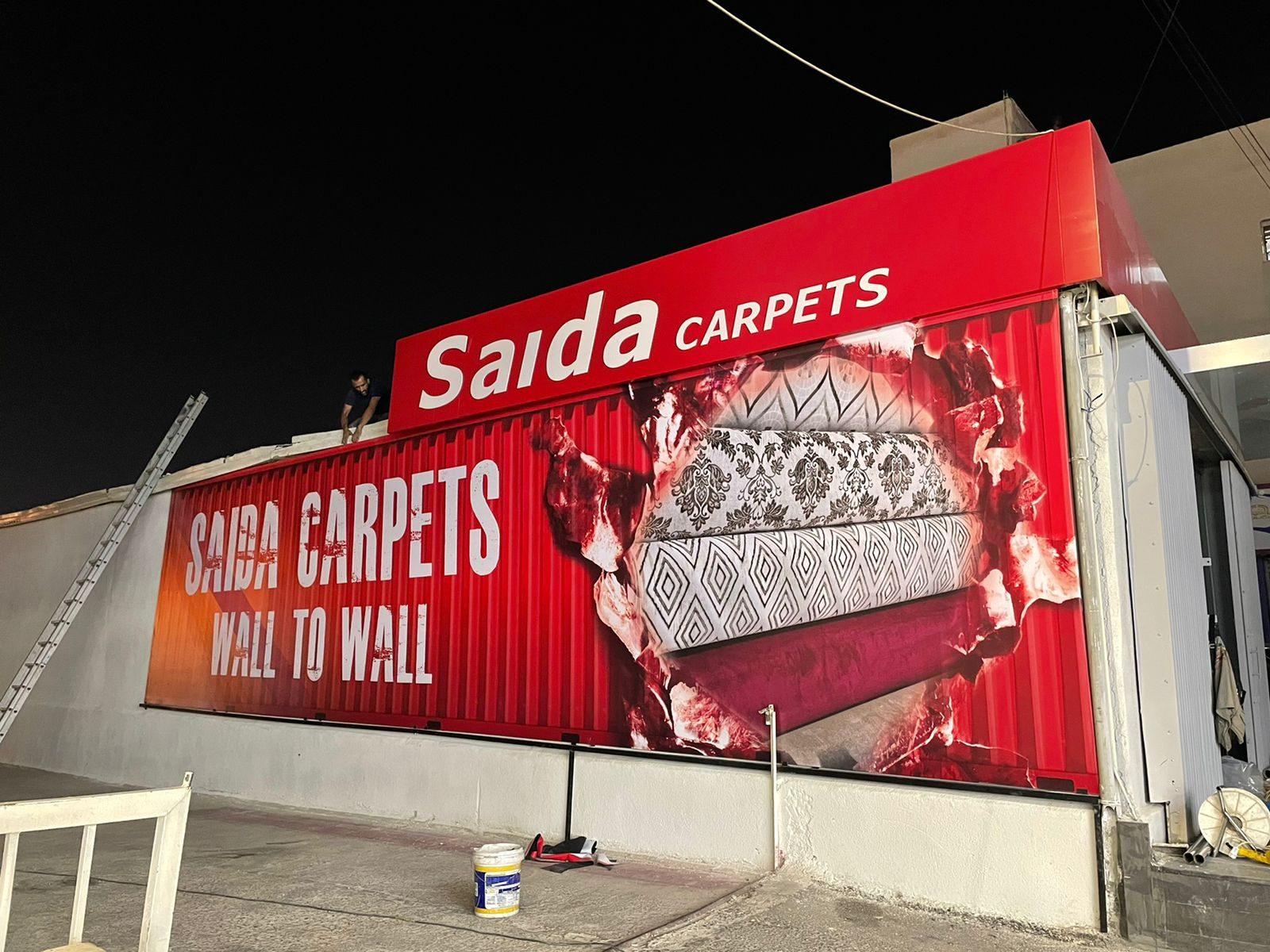 Red wall billboard with carpet imagery