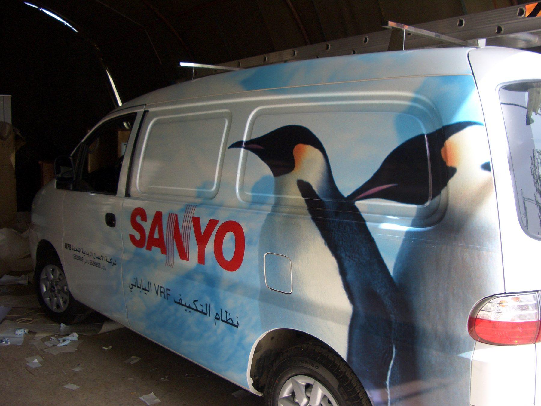 White van with a penguin graphic in the workshop during application