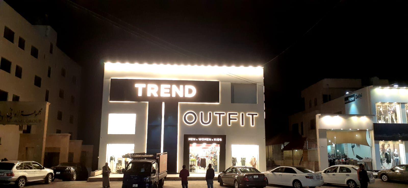 Lit clothing store facade at night