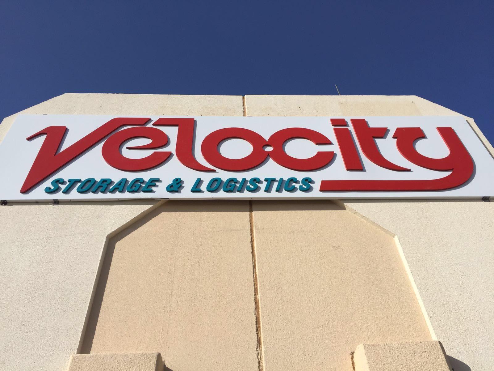 Close view of the red logo lettering on a white fascia panel