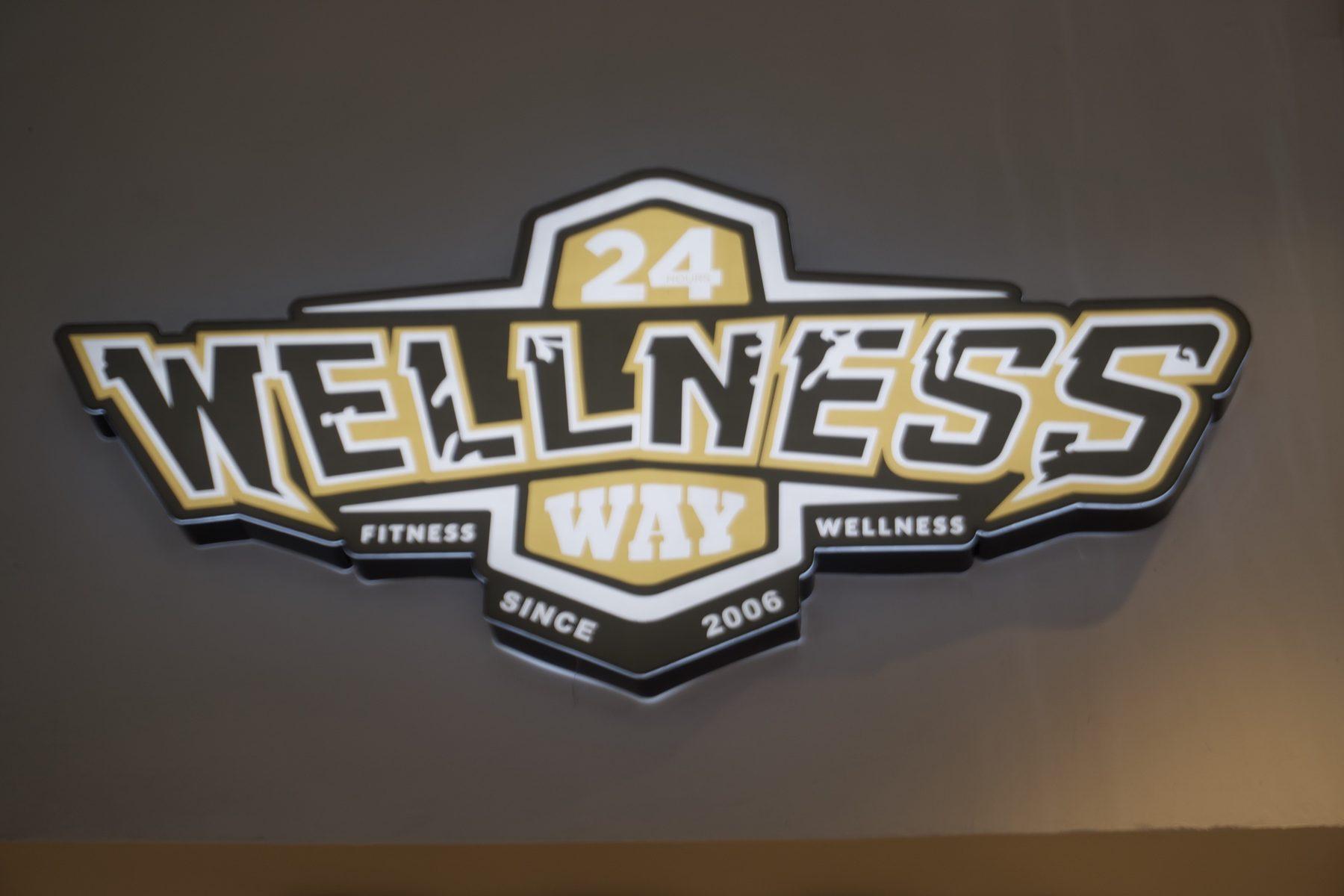 Dimensional logo sign on a plain wall, evenly lit