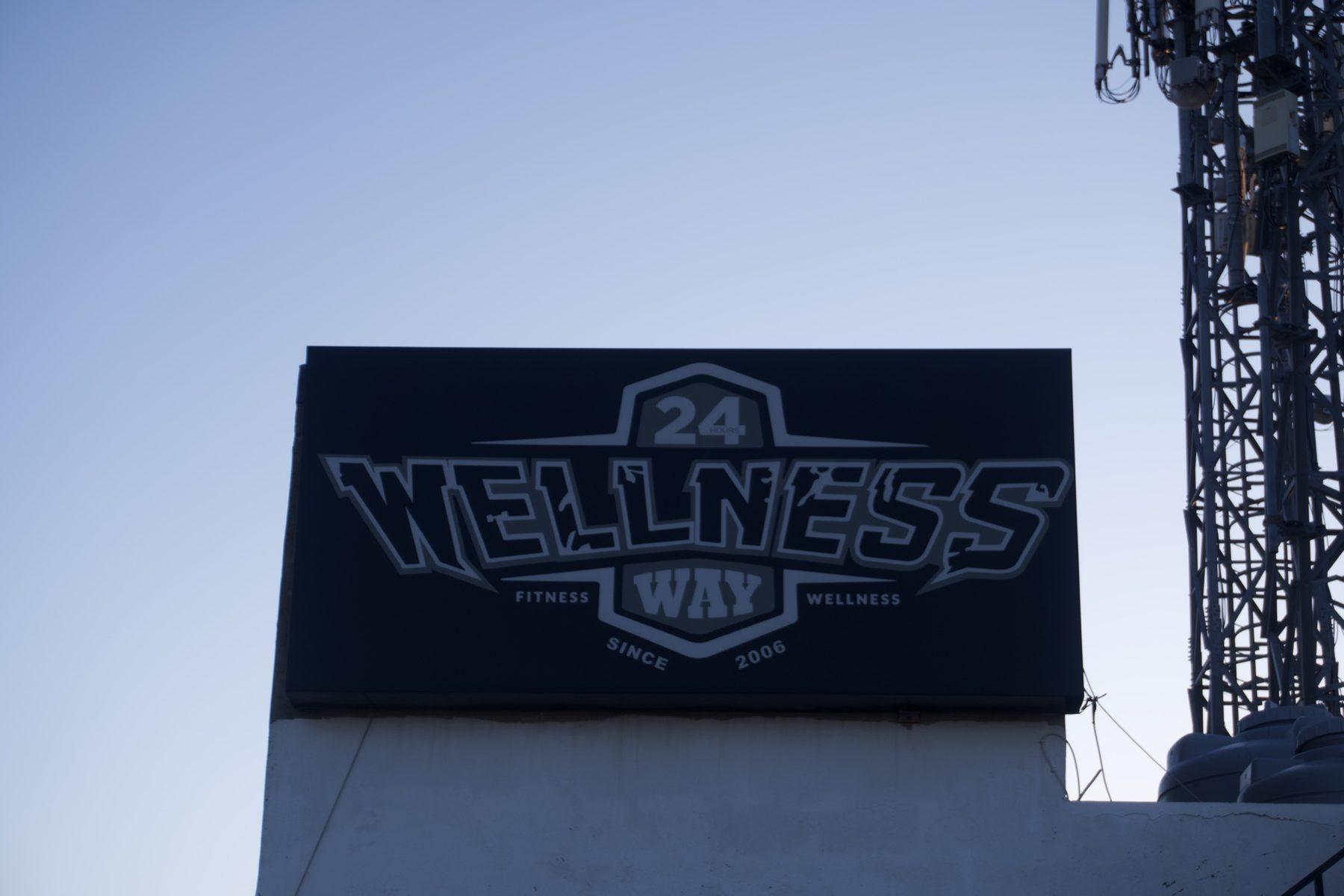 Rooftop logo sign against a clear sky