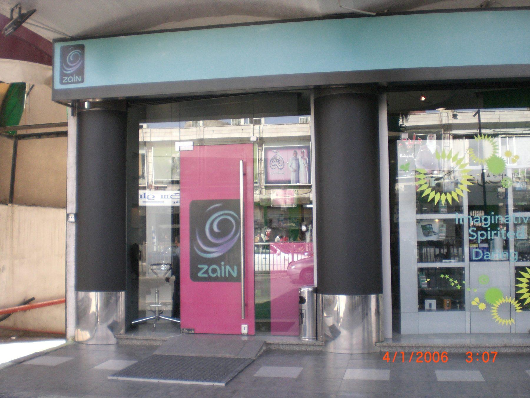 Storefront with pink logo door panel and window graphics
