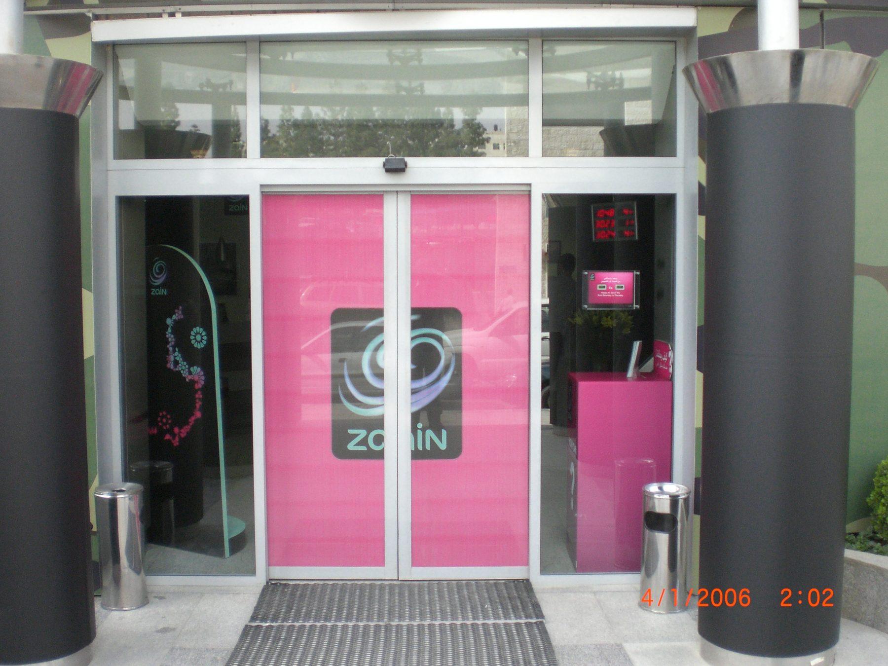 Entrance with pink double door panels and logo