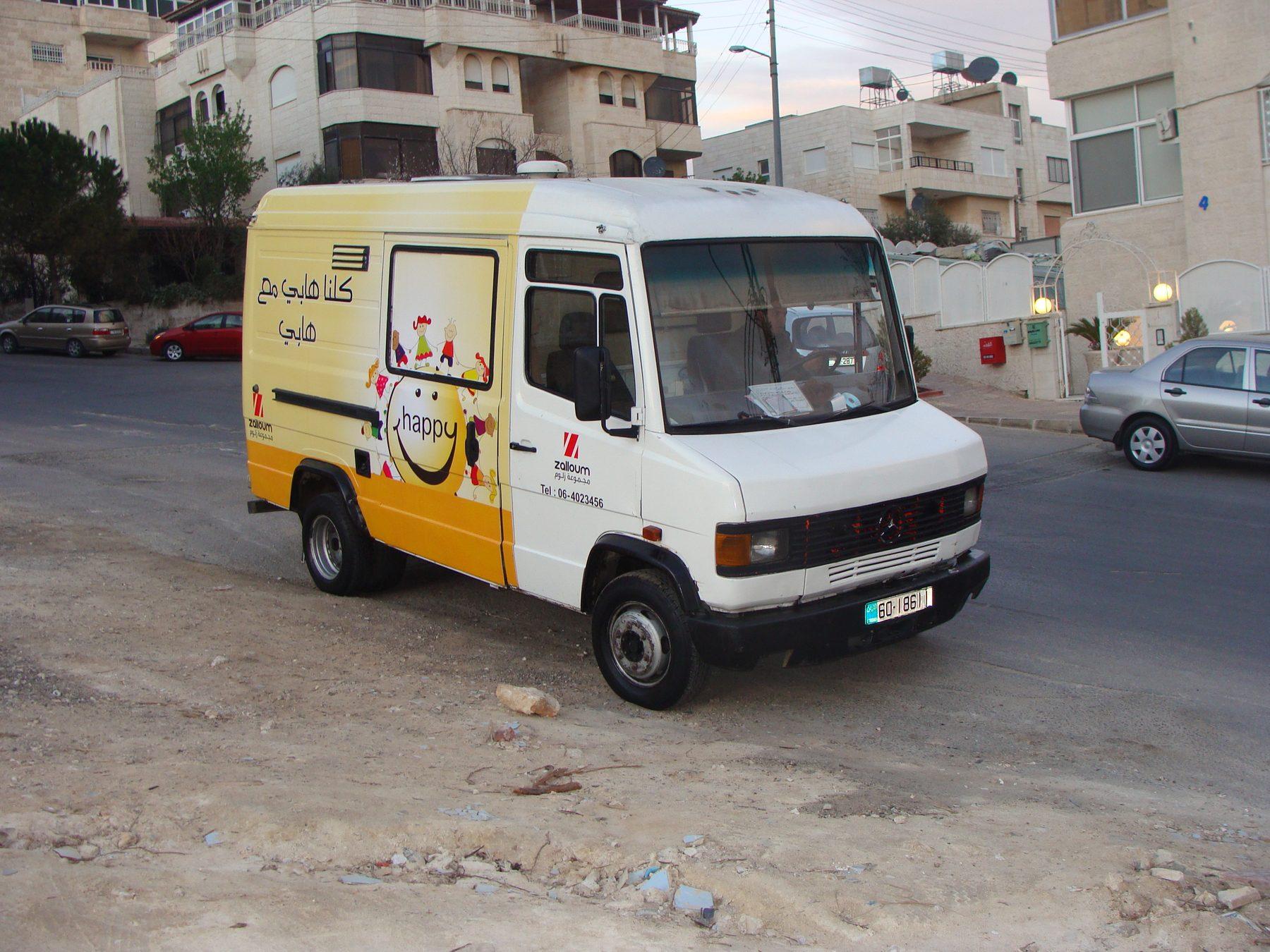 Van side with yellow wrap and character graphic