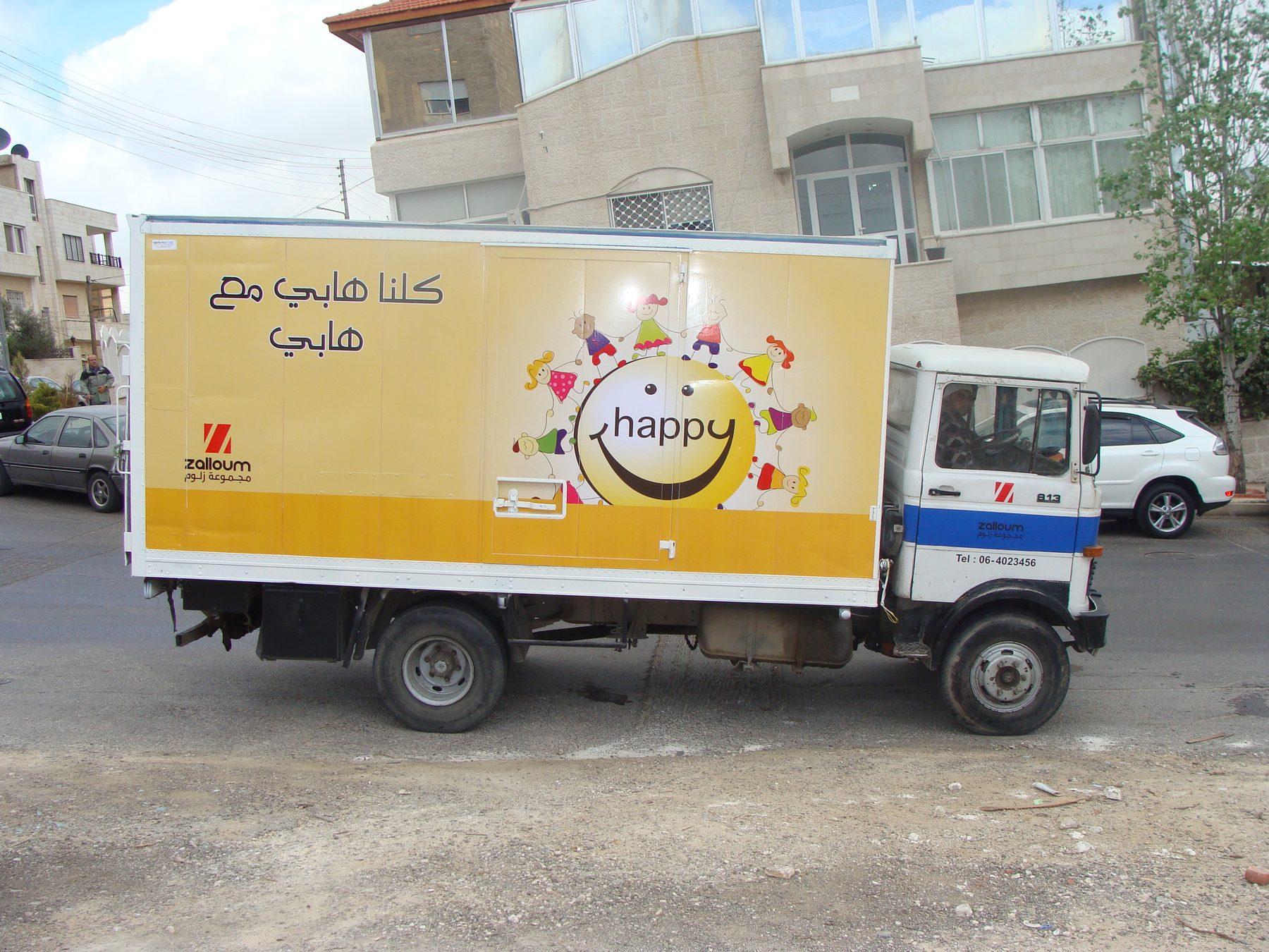 Box truck with yellow lower band and character graphic