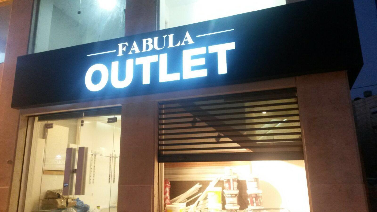Face-lit letters on a black fascia at dusk