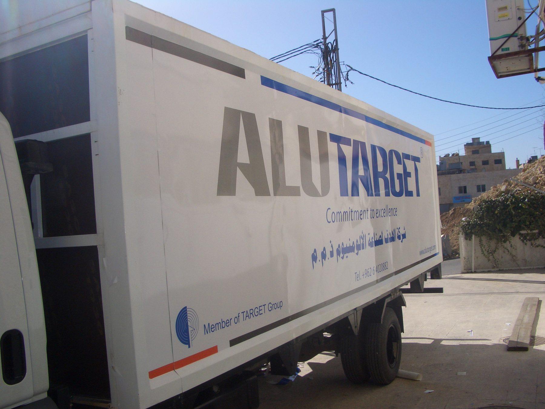 Box truck side with large lettering and tagline